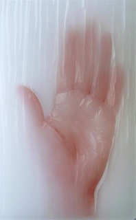 Catherine Truman, Wax Hand, 2009, digital image on paper embedded in ‘Paraplast’ tissue embedding wax, surface carved 21 x 13 x 1 cm Copyright and photo the artist